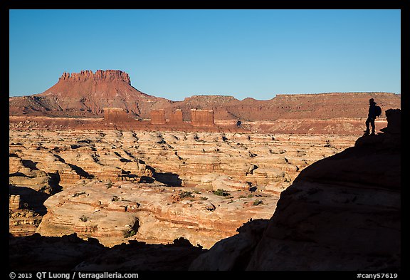 Hiker silhouette above the Maze and Chocolate drops. Canyonlands National Park, Utah, USA.