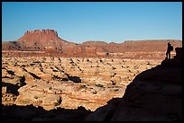 Hiker silhouette above the Maze and Chocolate drops. Canyonlands National Park, Utah, USA.