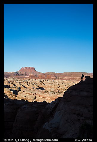 Hiker standing in silhouette above the Maze. Canyonlands National Park (color)