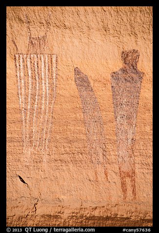 Bowing to large anthropomorphic figure with white stripes, Harvest Scene. Canyonlands National Park, Utah, USA.