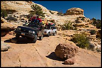 Vehicles on ledge in Teapot Canyon. Canyonlands National Park, Utah, USA.