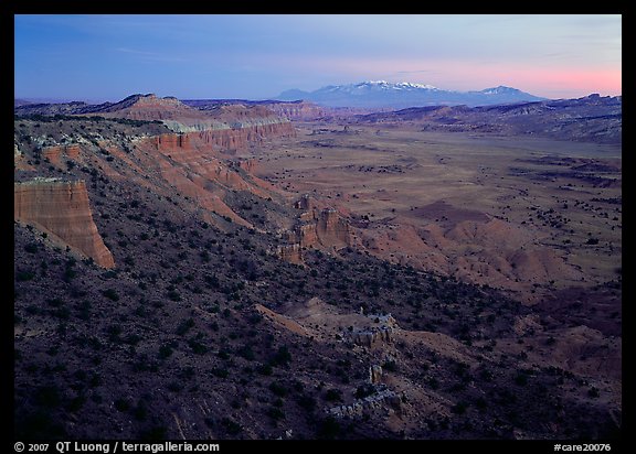 Cliffs, basin, and snowy mountains at dusk, Upper Desert, dusk. Capitol Reef National Park, Utah, USA.