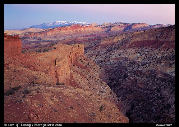 Waterpocket Fold and snowy mountains at dusk. Capitol Reef National Park, Utah, USA.