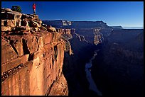 Hiker looking down into  Grand Canyon at Toroweap, early morning. Grand Canyon National Park, Arizona, USA. (color)