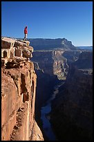 Man standing at  edge of  Grand Canyon at Toroweap, early morning. Grand Canyon National Park, Arizona, USA. (color)