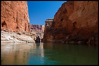 River-level view of redwall limestone canyon walls dropping straight into Colorado River. Grand Canyon National Park, Arizona, USA.