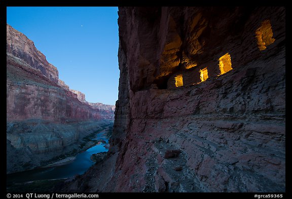 Ancient Nankoweap granaries with windows lit and Colorado River at dusk. Grand Canyon National Park, Arizona, USA.