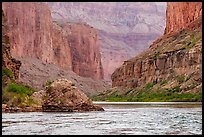The Colorado River winds past imposing red vertical walls. Grand Canyon National Park ( color)