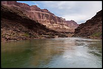 The Colorado River flows past angled strata and bright buttes. Grand Canyon National Park ( color)