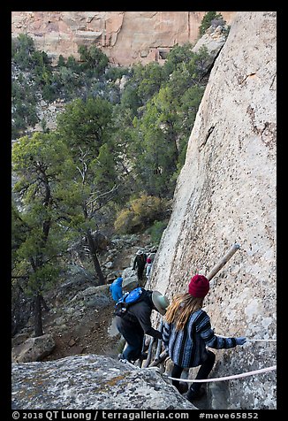 Tour participants negotiate cliff. Mesa Verde National Park (color)