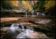 North Creek flowing over red travertine terraces in autumn. Zion National Park, Utah, USA.