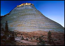 Checkerboard Mesa with top illuminated by sunrise. Zion National Park, Utah, USA.