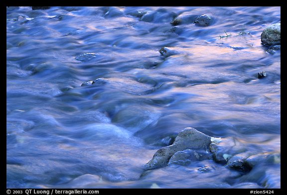 Water flowing in the Virgin River, with reflections from cliffs. Zion National Park, Utah, USA.