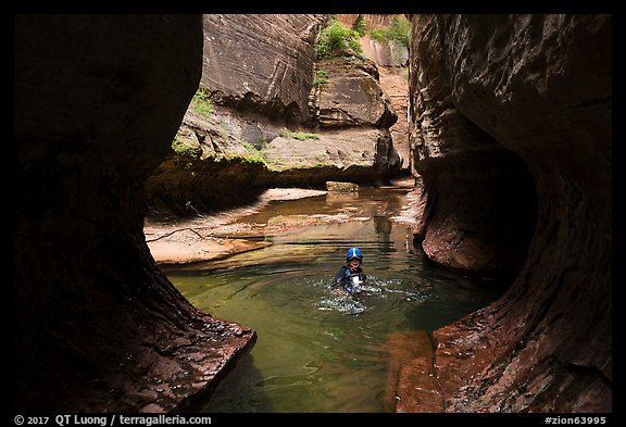 Canyonneer swims in pool, Upper Subway. Zion National Park, Utah (color)