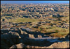 Prairie and eroded ridges stretching to horizon, early morning. Badlands National Park ( color)