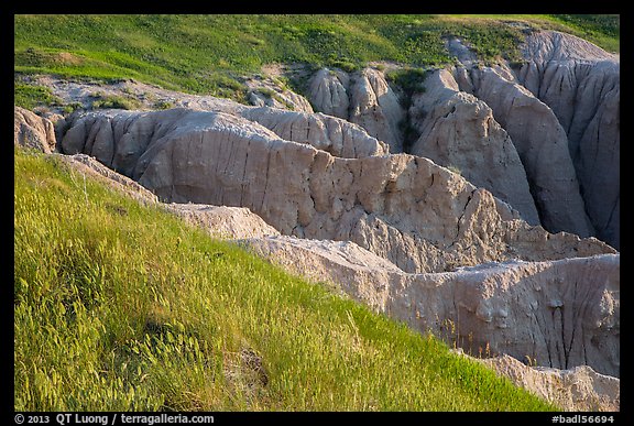 Badlands beneath mixed grass prairie plateau. Badlands National Park (color)