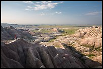 Park visitor looking, Panorama Point. Badlands National Park, South Dakota, USA. (color)