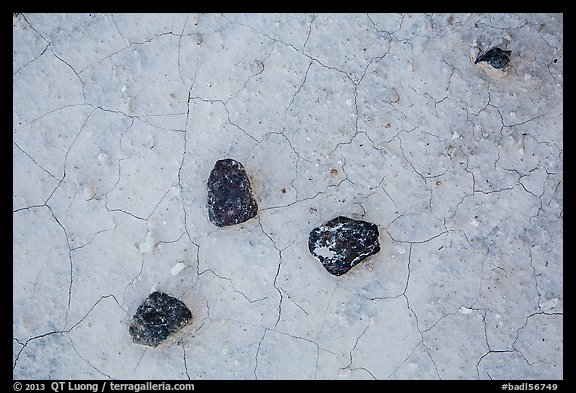 Dark rock on soil with fine cracks. Badlands National Park, South Dakota, USA.