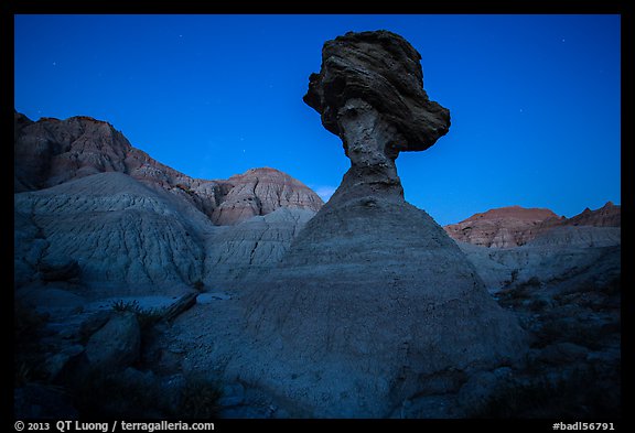 Pedestal rock at badlands at dusk. Badlands National Park, South Dakota, USA.