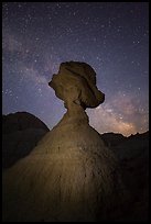 Balanced rock at night with starry sky and Milky Way. Badlands National Park, South Dakota, USA.