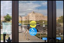 Buttes, Ben Reifel Visitor Center window reflexion. Badlands National Park, South Dakota, USA. (color)