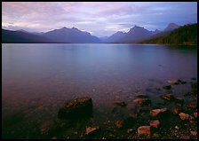 Rocks, Lake Mc Donald, and mountains at sunset. Glacier National Park, Montana, USA. (color)