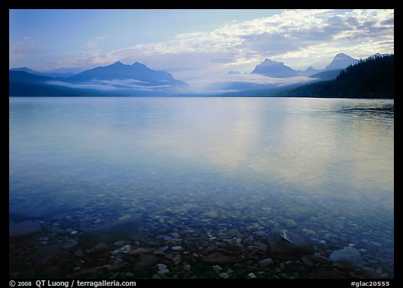 Lake McDonald with clouds and mountains reflected in early morning. Glacier National Park, Montana, USA.