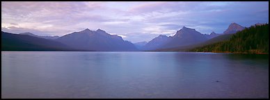 Mountains rising above calm lake in the evening. Glacier National Park, Montana, USA.