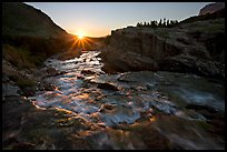 Outlet stream of Swiftcurrent Lake, sunrise. Glacier National Park, Montana, USA.