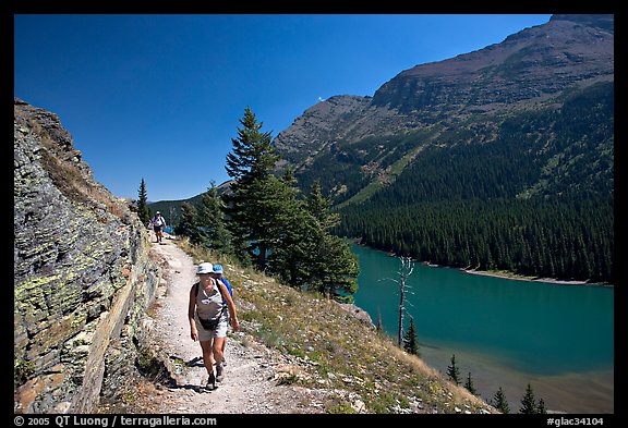 Hikers on trail above Lake Josephine. Glacier National Park, Montana, USA.