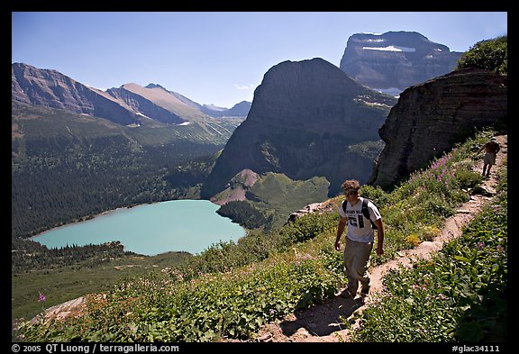 Hikers on trail overlooking Grinnell Lake. Glacier National Park, Montana, USA.