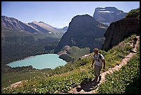 Hikers on trail overlooking Grinnell Lake. Glacier National Park, Montana, USA. (color)