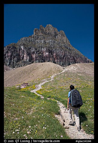 Backpacker and peak near Logan Pass. Glacier National Park, Montana, USA.