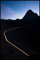 Going-to-the-Sun road at dusk with car light trail. Glacier National Park, Montana, USA.