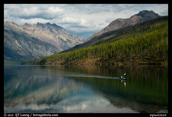 Kayaker paddling back to shore as clouds threaten, Kintla Lake. Glacier National Park (color)