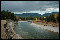 Dark clouds over North Fork of Flathead River in autumn. Glacier National Park, Montana, USA.