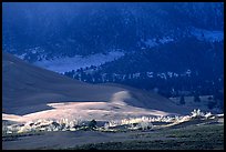 Storm light illuminates portions of the dune field. Great Sand Dunes National Park, Colorado, USA. (color)