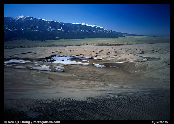 Sand dunes with patches of snow seen from above. Great Sand Dunes National Park and Preserve, Colorado, USA.