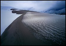 Zig-zag pattern of sand amongst Snow on the dunes. Great Sand Dunes National Park, Colorado, USA. (color)