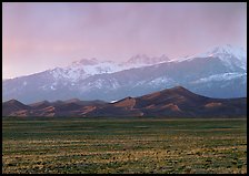 Flats, sand dunes, and snowy Sangre de Christo mountains. Great Sand Dunes National Park and Preserve, Colorado, USA.