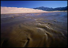 Medano creek with shifting sands, dunes and Sangre de Christo mountains. Great Sand Dunes National Park, Colorado, USA. (color)