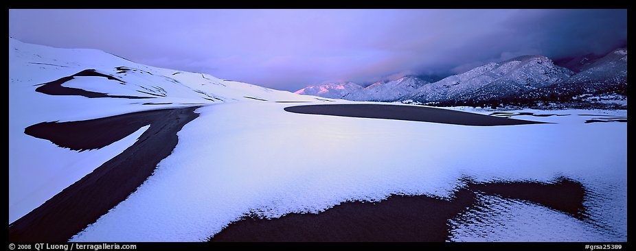 Snow-covered dune landscape and mountains at dawn. Great Sand Dunes National Park (color)