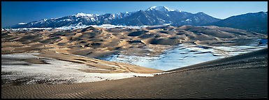 Landscape of sand dunes and mountains in winter. Great Sand Dunes National Park (Panoramic color)