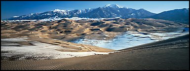 Landscape of sand dunes and mountains in winter. Great Sand Dunes National Park and Preserve, Colorado, USA.