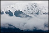 Snowy Sangre de Cristo Mountains above clouds. Great Sand Dunes National Park and Preserve, Colorado, USA.