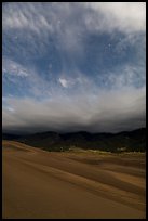 Dunes, moonlit clouds, and stars. Great Sand Dunes National Park and Preserve, Colorado, USA.
