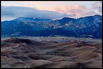 Dunes and mountains with fall colors at dusk. Great Sand Dunes National Park, Colorado, USA. (color)