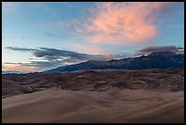 Dune field and Sangre de Cristo mountains with cloud lighted by sunset. Great Sand Dunes National Park, Colorado, USA. (color)