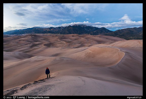 Hiker climbing high dune. Great Sand Dunes National Park and Preserve (color)