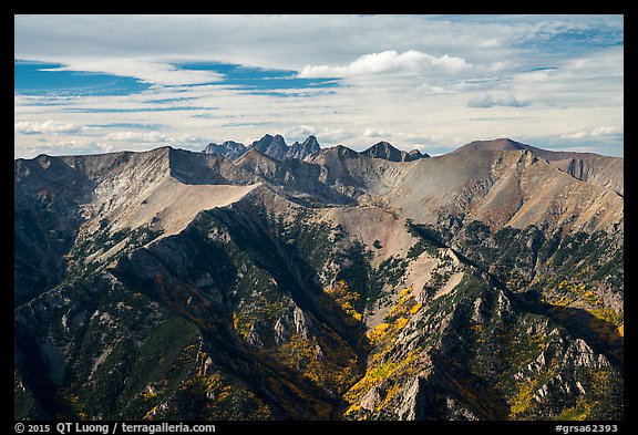 Rocky Sangre de Cristo mountain brightened by aspens in fall foliage. Great Sand Dunes National Park and Preserve, Colorado, USA.